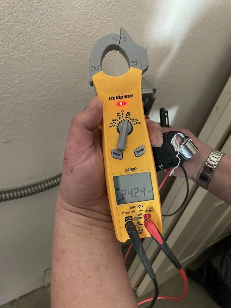 Voltage testing with clamp meter during Electrical Installation Services in Shelby